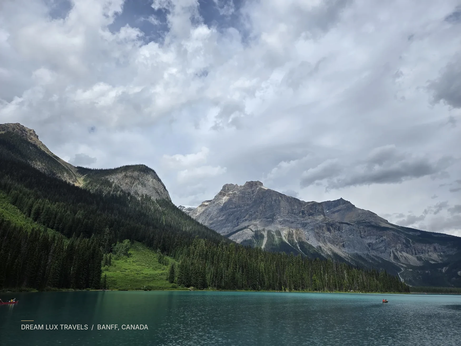 Mountain lake and forested slopes in the Canadian Rockies.