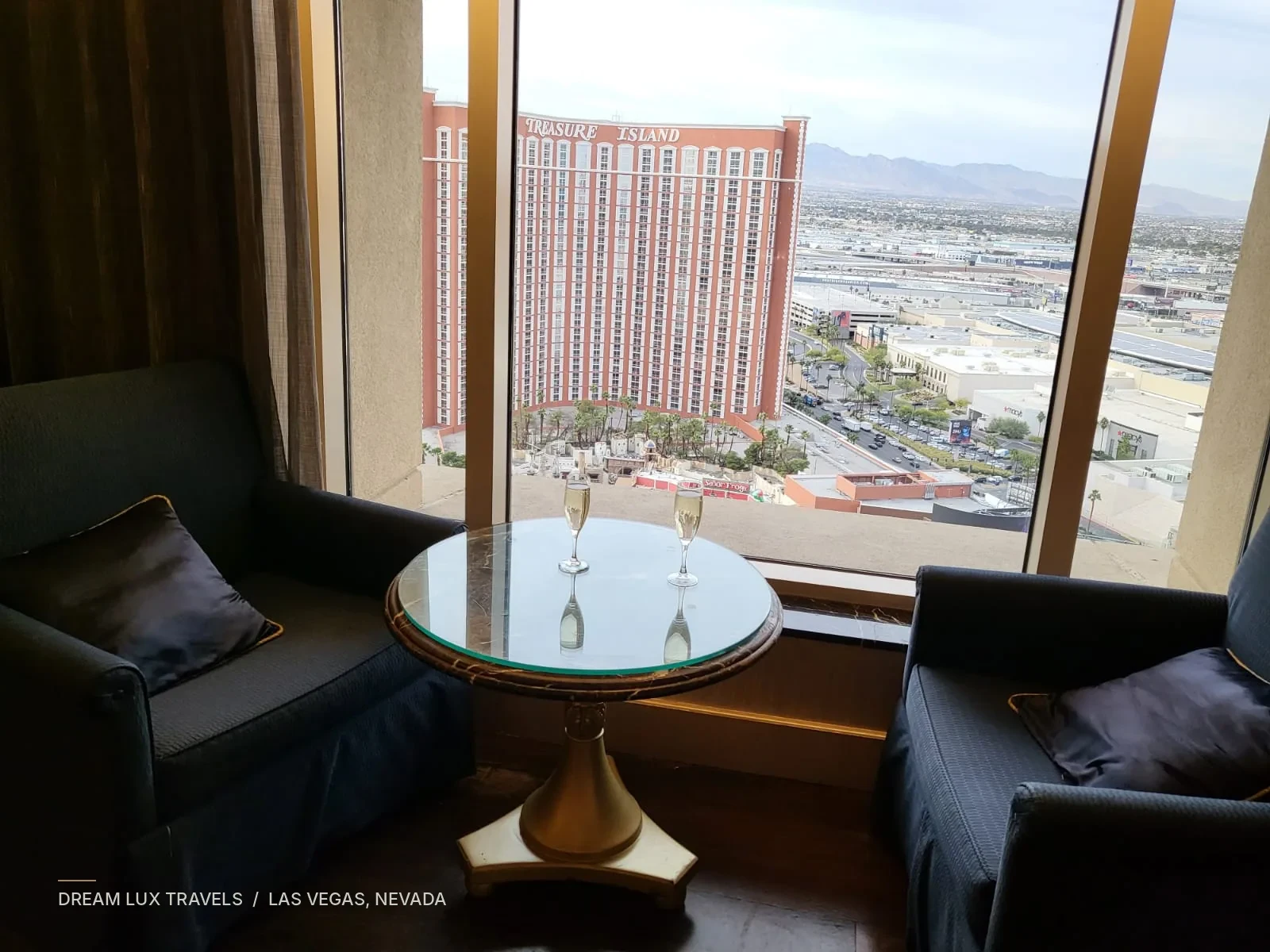 Original Palazzo suite photograph: window seating and two champagne glasses overlooking Las Vegas.
