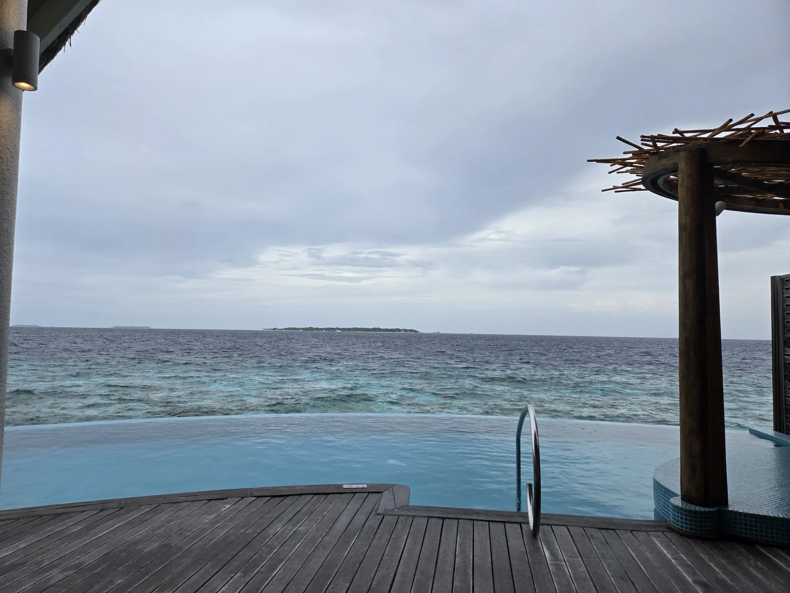 Overwater villa deck and plunge pool overlooking the Indian Ocean at Milaidhoo.