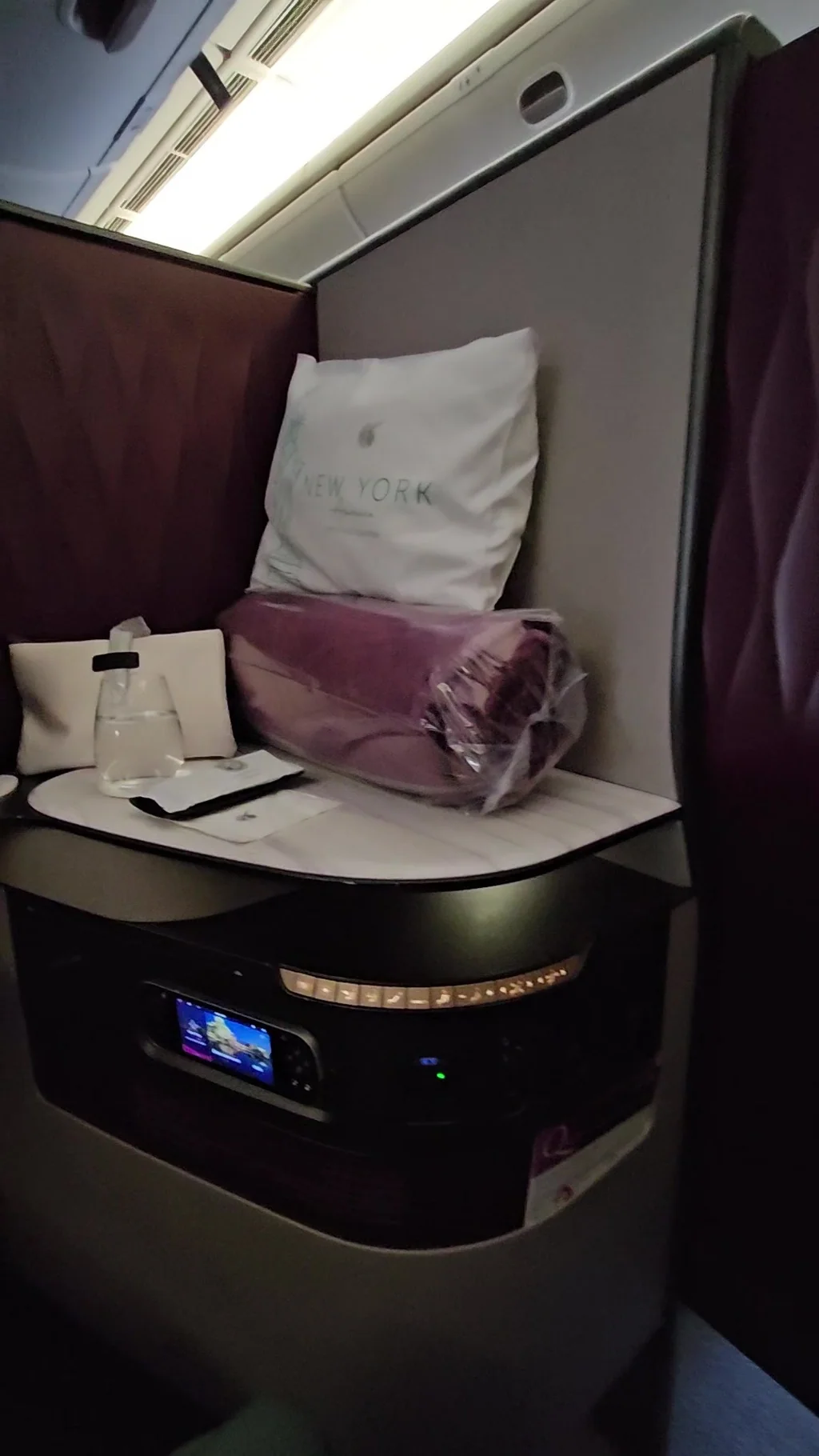 Private Qatar Airways Qsuite business-class seat and enclosed cabin furnishings on a flight in November 2023.