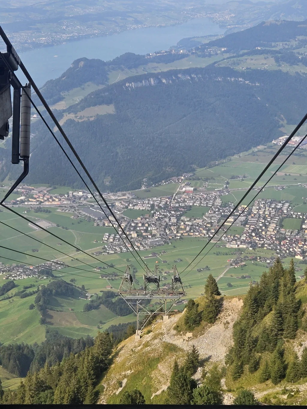 View down the cable-car route toward green valleys during the Stanserhorn excursion.